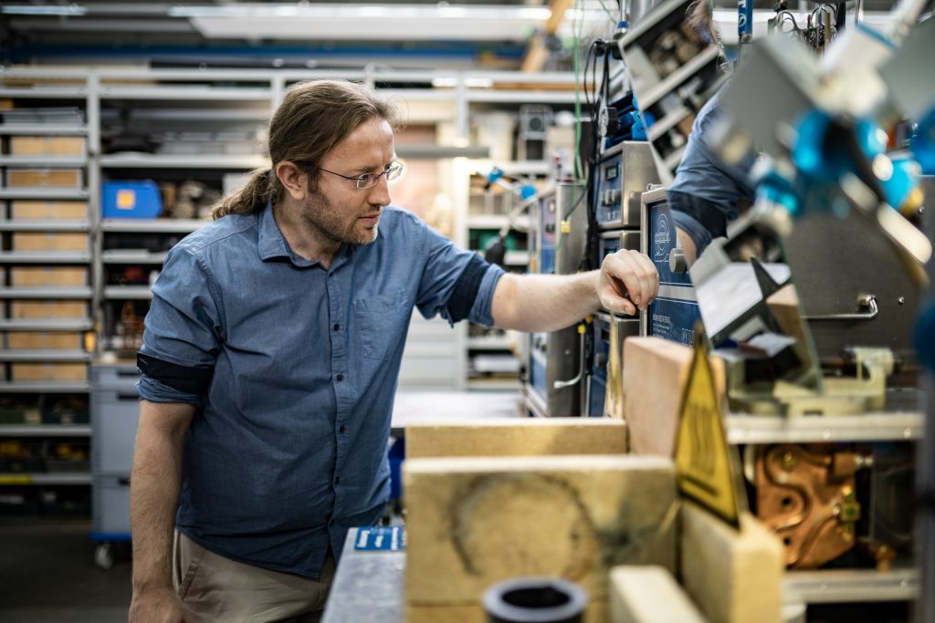 Developer looks at inverter in lab