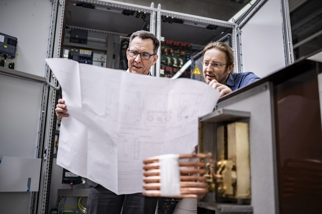 Two developers bent over plan